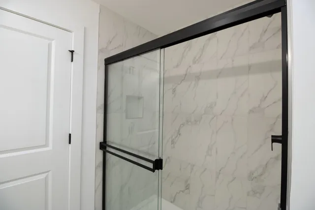 a bathroom with a glass shower door