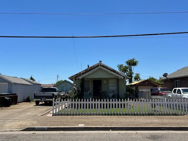 320 Wallis Avenue Gustine, CA 95322 - Photo 1 of 1 a front view of a house with a garden
