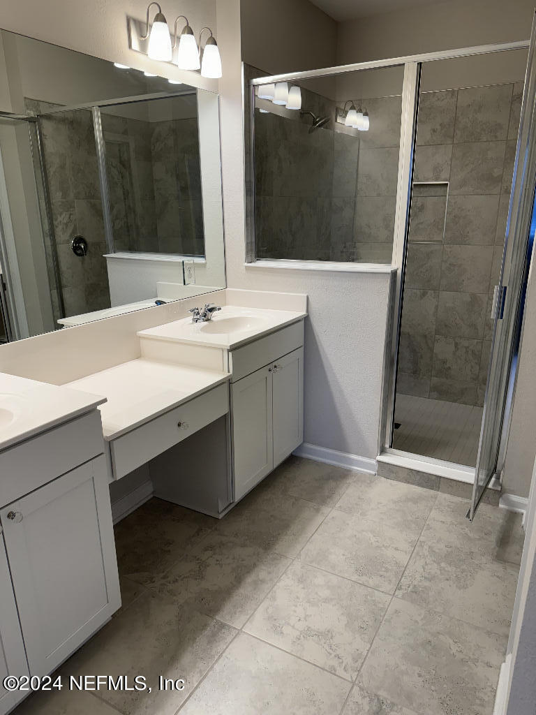 168 Pine Bluff Drive St. Augustine, FL 32092 - Photo 11 of 12 a bathroom with a double vanity sink and mirror