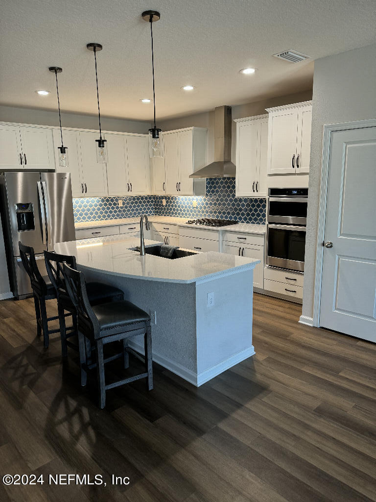 168 Pine Bluff Drive St. Augustine, FL 32092 - Photo 2 of 12 a kitchen with kitchen island granite countertop a sink a counter top space stainless steel appliances and cabinets