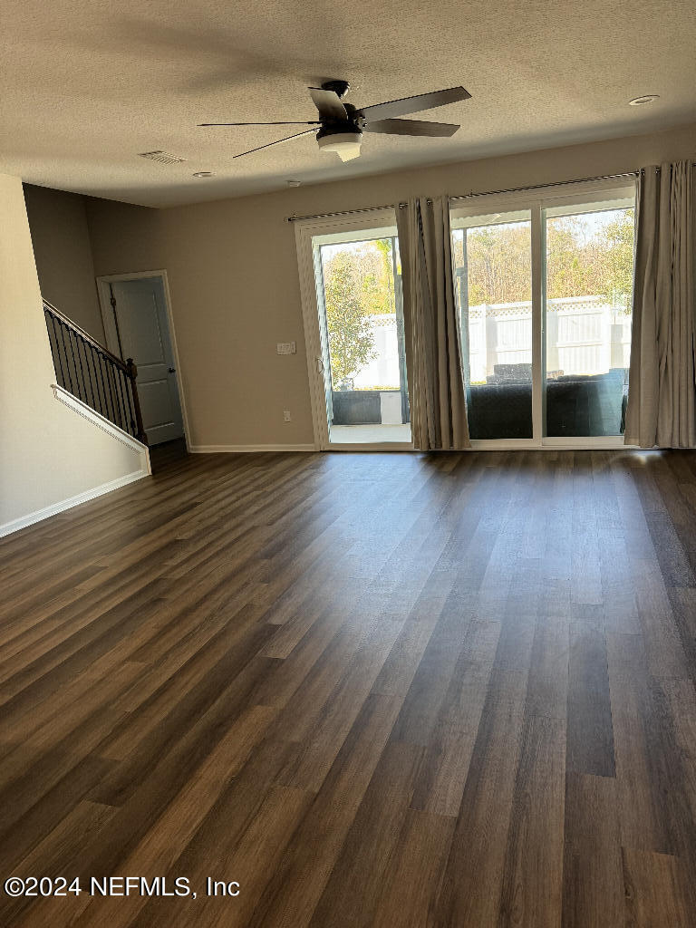 168 Pine Bluff Drive St. Augustine, FL 32092 - Photo 3 of 12 an empty room with wooden floor and windows