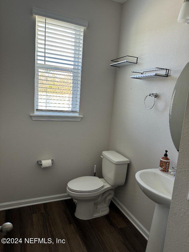 168 Pine Bluff Drive St. Augustine, FL 32092 - Photo 4 of 12 a white toilet sitting next to a bathroom sink