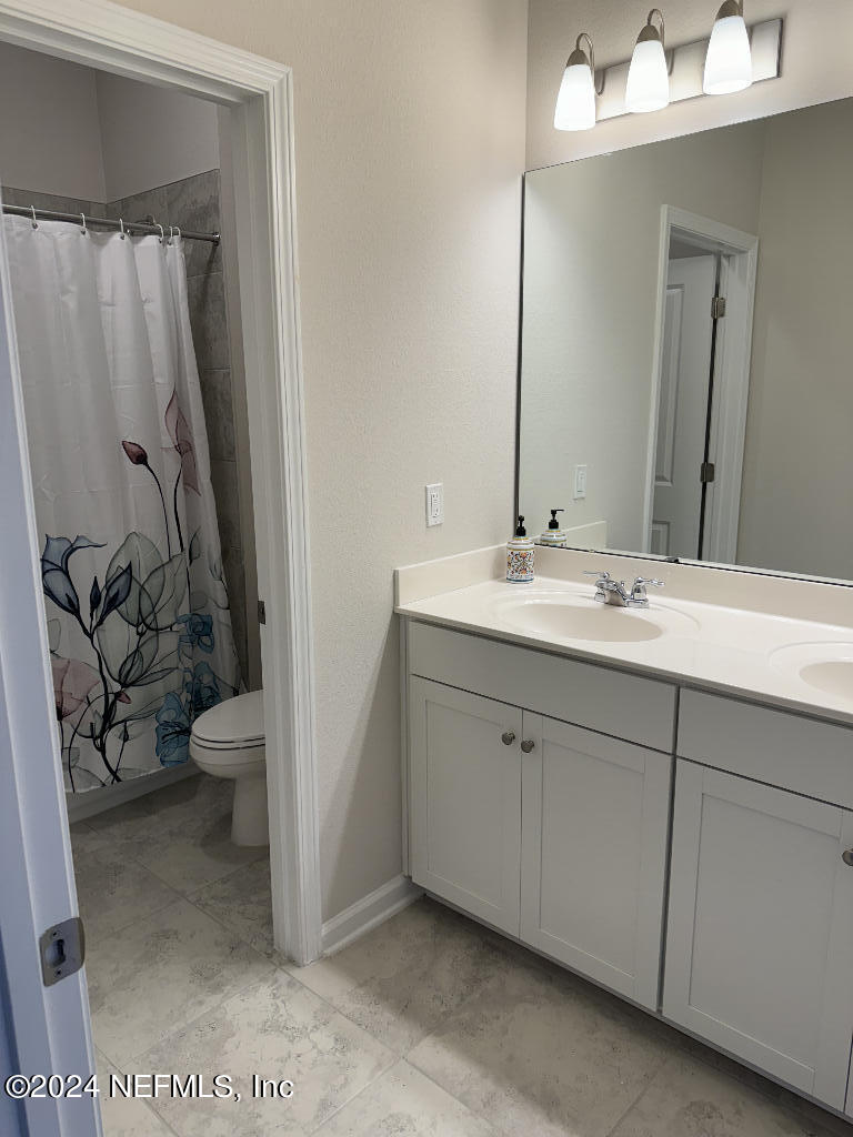 168 Pine Bluff Drive St. Augustine, FL 32092 - Photo 5 of 12 a bathroom with a granite countertop sink toilet and shower