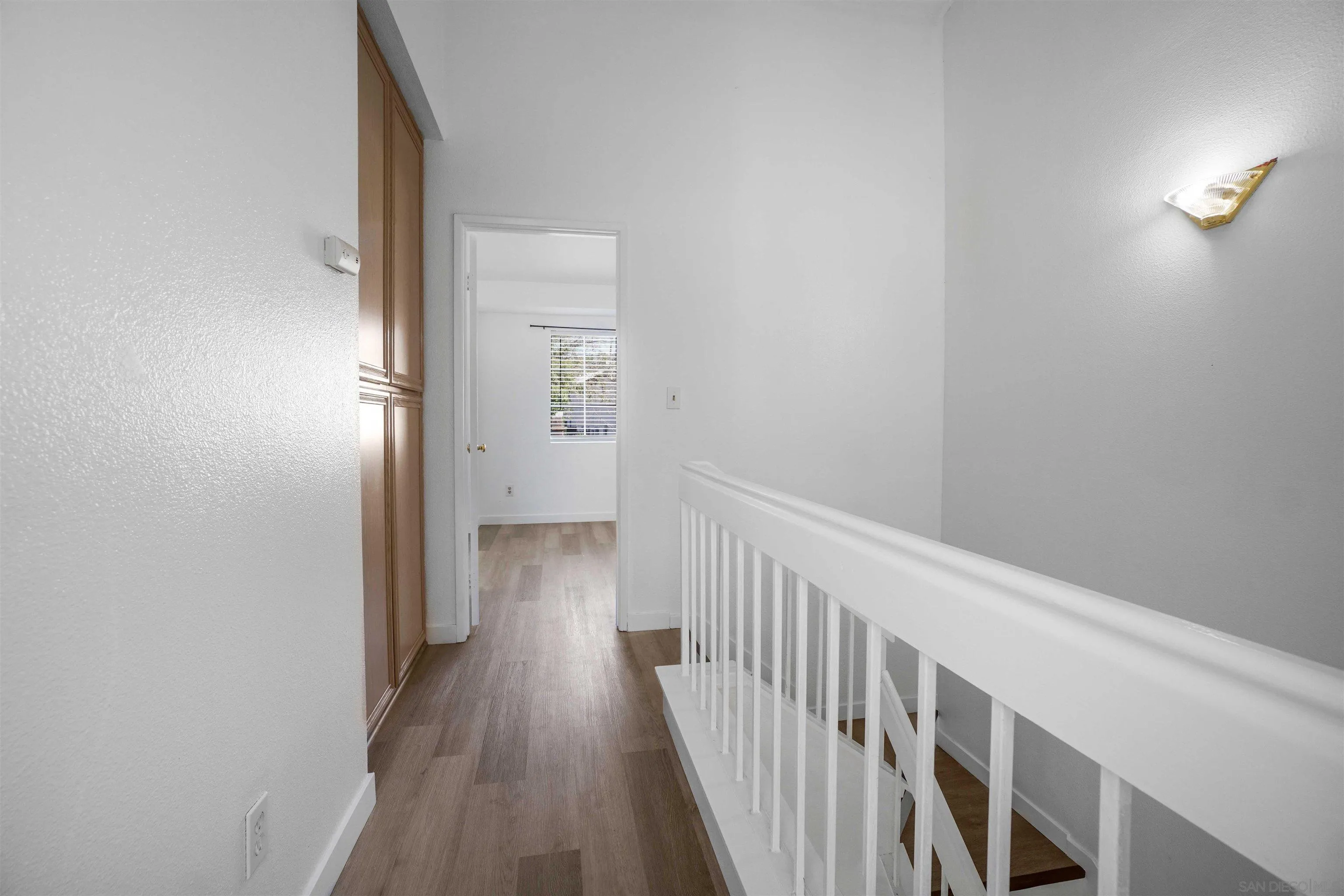 8966 Arlingdale Way Spring Valley, CA 91977 - Photo 11 of 24 a view of a hallway with wooden floor
