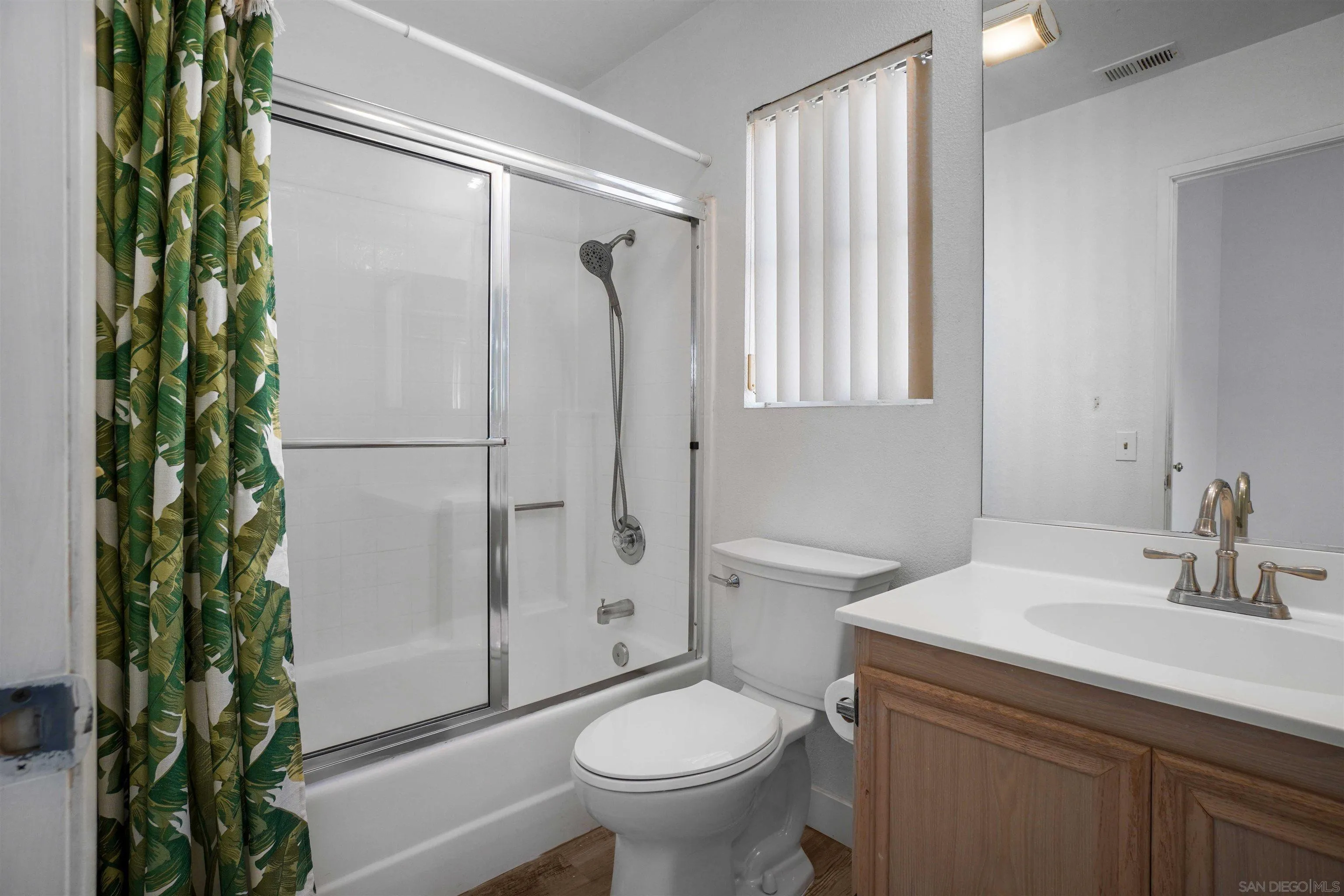 8966 Arlingdale Way Spring Valley, CA 91977 - Photo 14 of 24 a bathroom with a sink toilet and shower