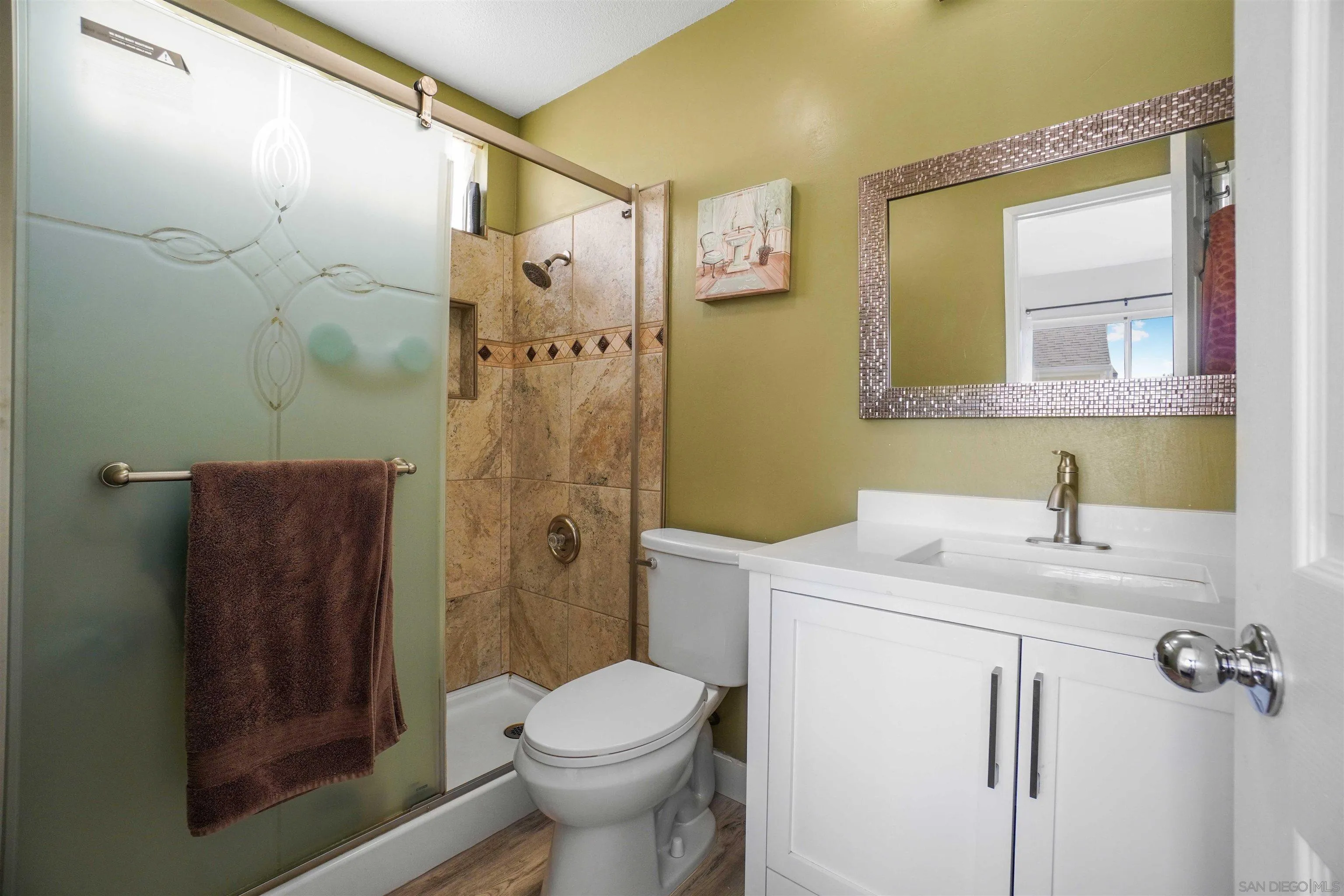 8966 Arlingdale Way Spring Valley, CA 91977 - Photo 17 of 24 a bathroom with a sink a toilet and shower