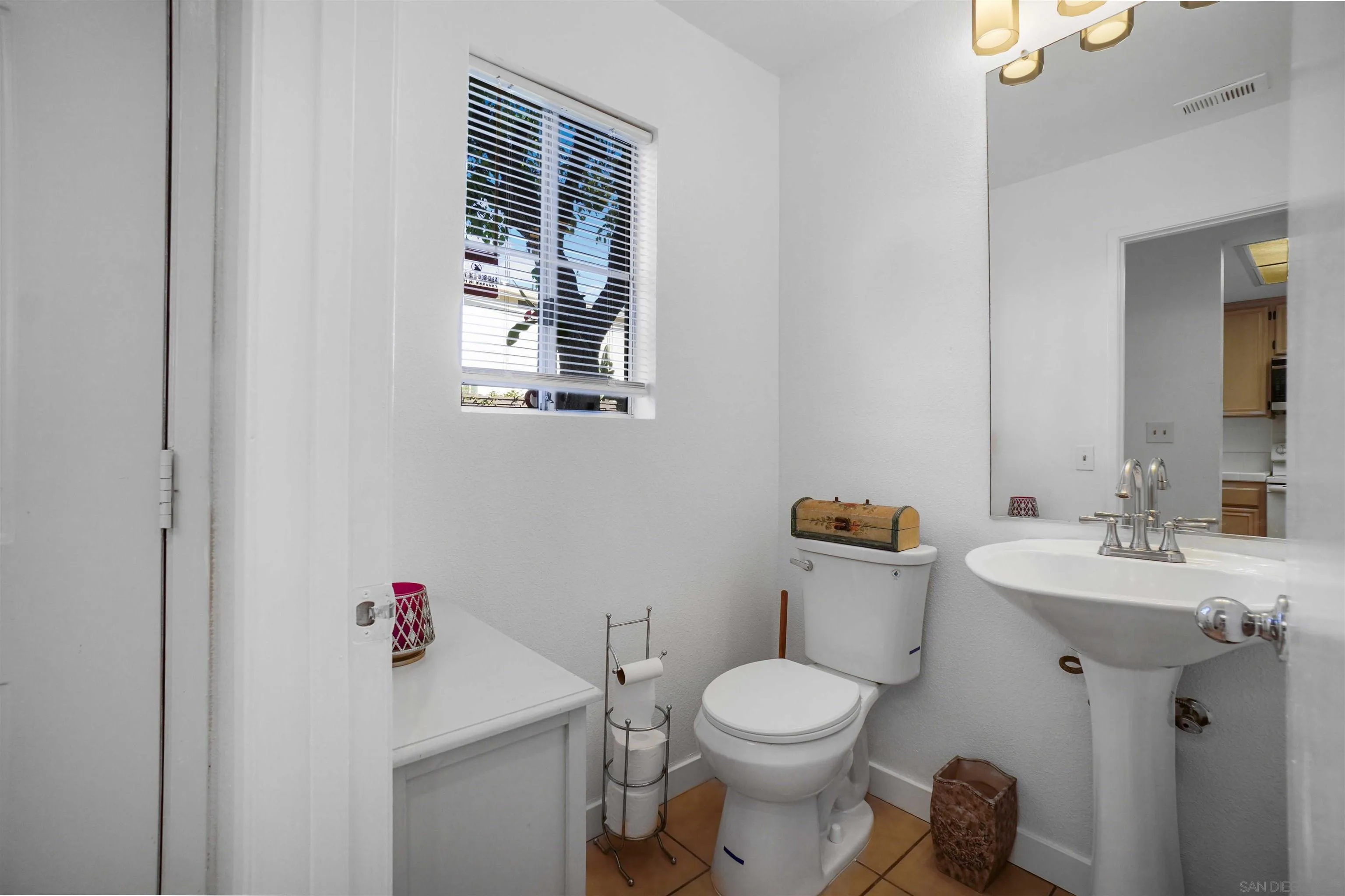 8966 Arlingdale Way Spring Valley, CA 91977 - Photo 5 of 24 a bathroom with a toilet sink and mirror