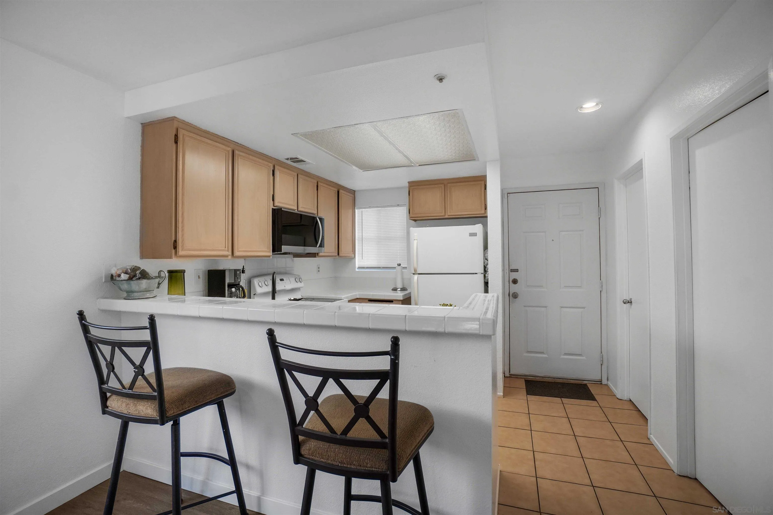 8966 Arlingdale Way Spring Valley, CA 91977 - Photo 7 of 24 a kitchen with a sink cabinets and window