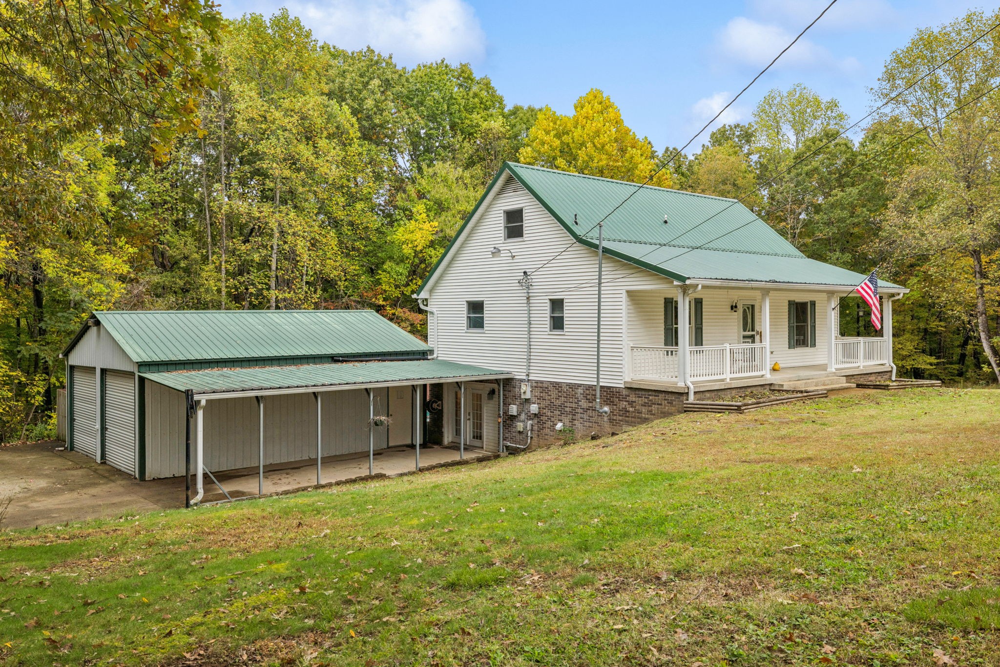a view of a house with a yard and sitting area