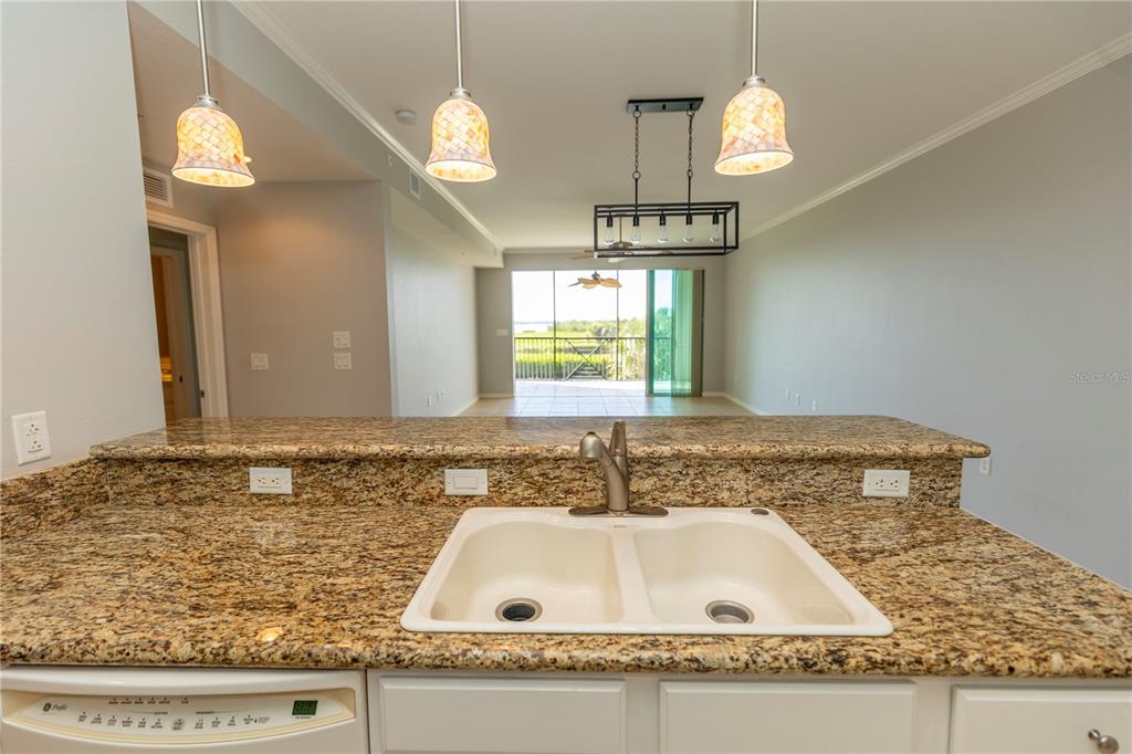 9203 Griggs Road, Unit B102 Englewood, FL 34224 - Photo 13 of 66 a bathroom with a granite countertop sink and a mirror