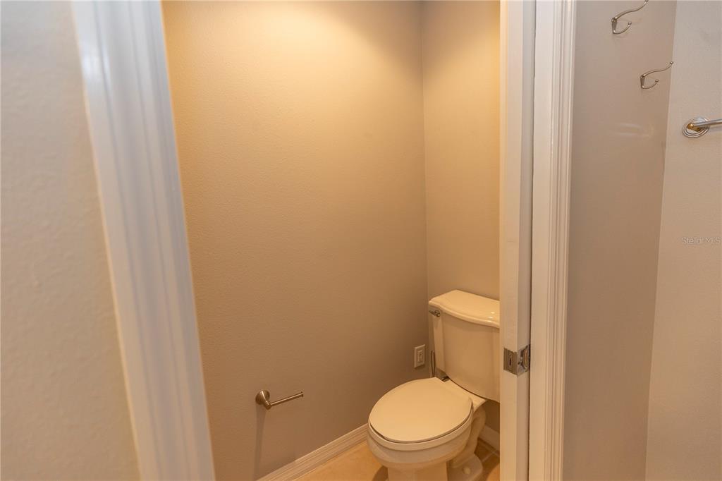 9203 Griggs Road, Unit B102 Englewood, FL 34224 - Photo 25 of 66 a white toilet sitting next to a shower