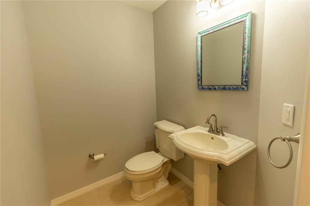 9203 Griggs Road, Unit B102 Englewood, FL 34224 - Photo 30 of 66 a bathroom with a sink mirror and toilet