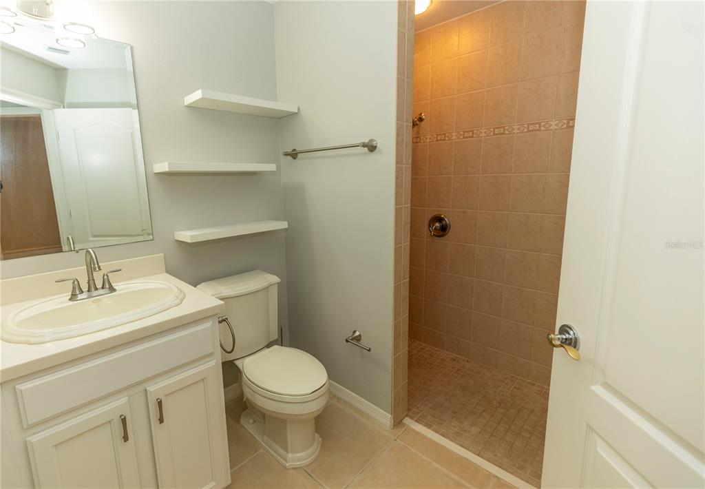 9203 Griggs Road, Unit B102 Englewood, FL 34224 - Photo 31 of 66 a bathroom with a sink a toilet and shower
