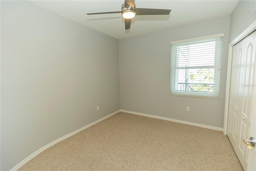 9203 Griggs Road, Unit B102 Englewood, FL 34224 - Photo 33 of 66 an empty room with windows and fan