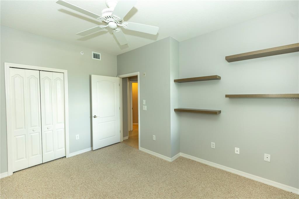 9203 Griggs Road, Unit B102 Englewood, FL 34224 - Photo 37 of 66 a view of an empty room with a ceiling fan