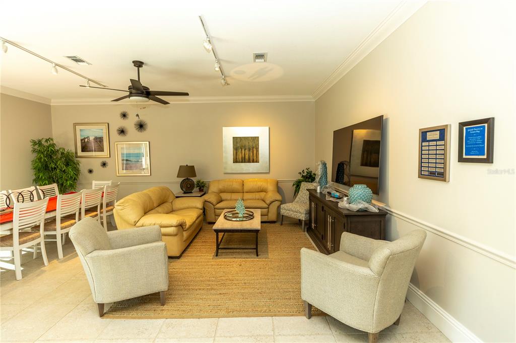 9203 Griggs Road, Unit B102 Englewood, FL 34224 - Photo 40 of 66 a living room with furniture kitchen view and a chandelier