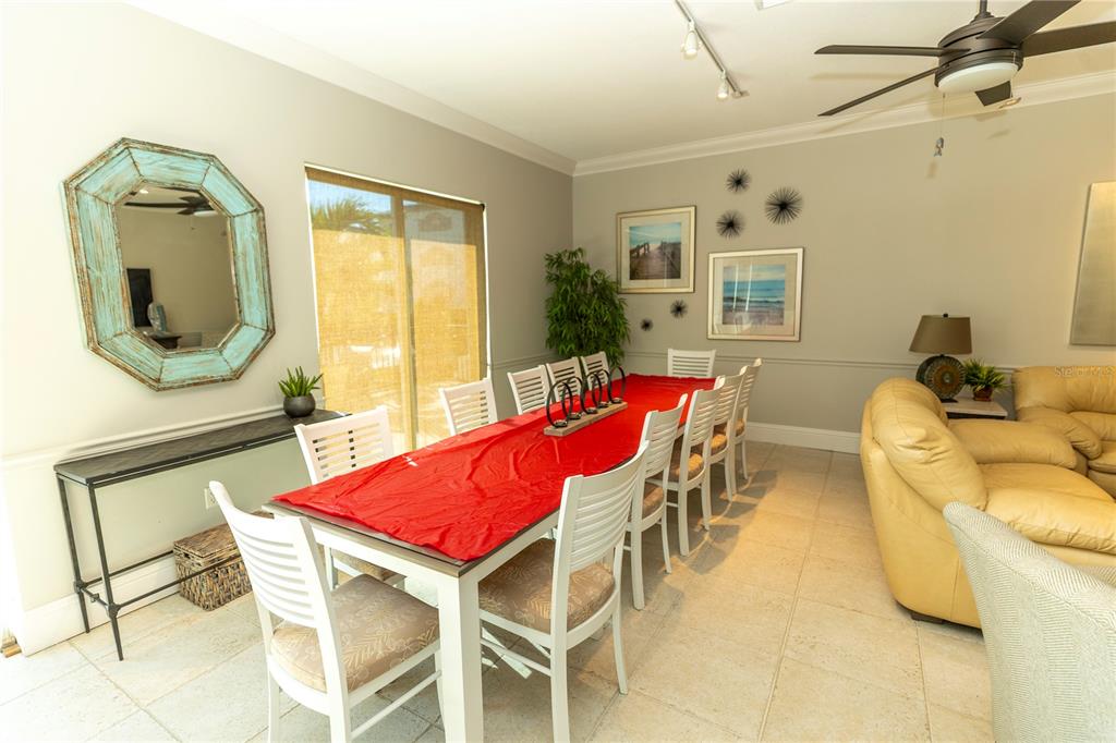 9203 Griggs Road, Unit B102 Englewood, FL 34224 - Photo 41 of 66 a dining room with furniture and wooden floor