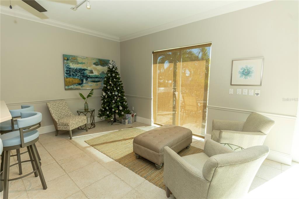 9203 Griggs Road, Unit B102 Englewood, FL 34224 - Photo 42 of 66 a living room with furniture and a window