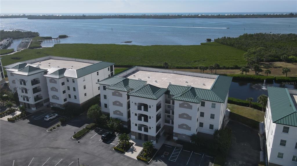 9203 Griggs Road, Unit B102 Englewood, FL 34224 - Photo 52 of 66 an aerial view of multiple houses with a yard