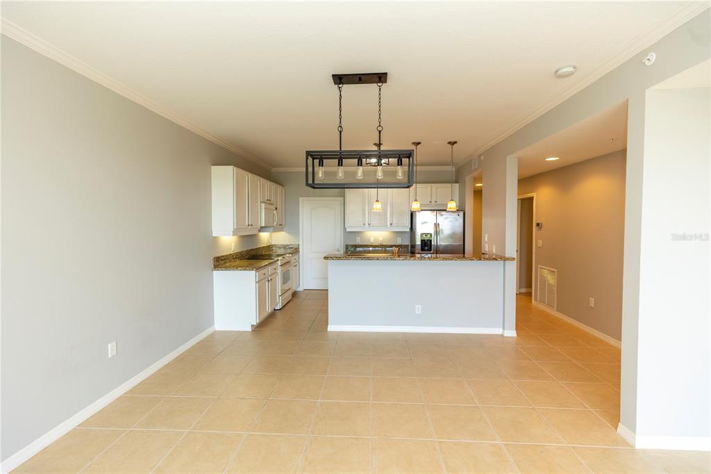 9203 Griggs Road, Unit B102 Englewood, FL 34224 - Photo 9 of 66 a view of a kitchen with a sink stainless steel appliances and cabinets