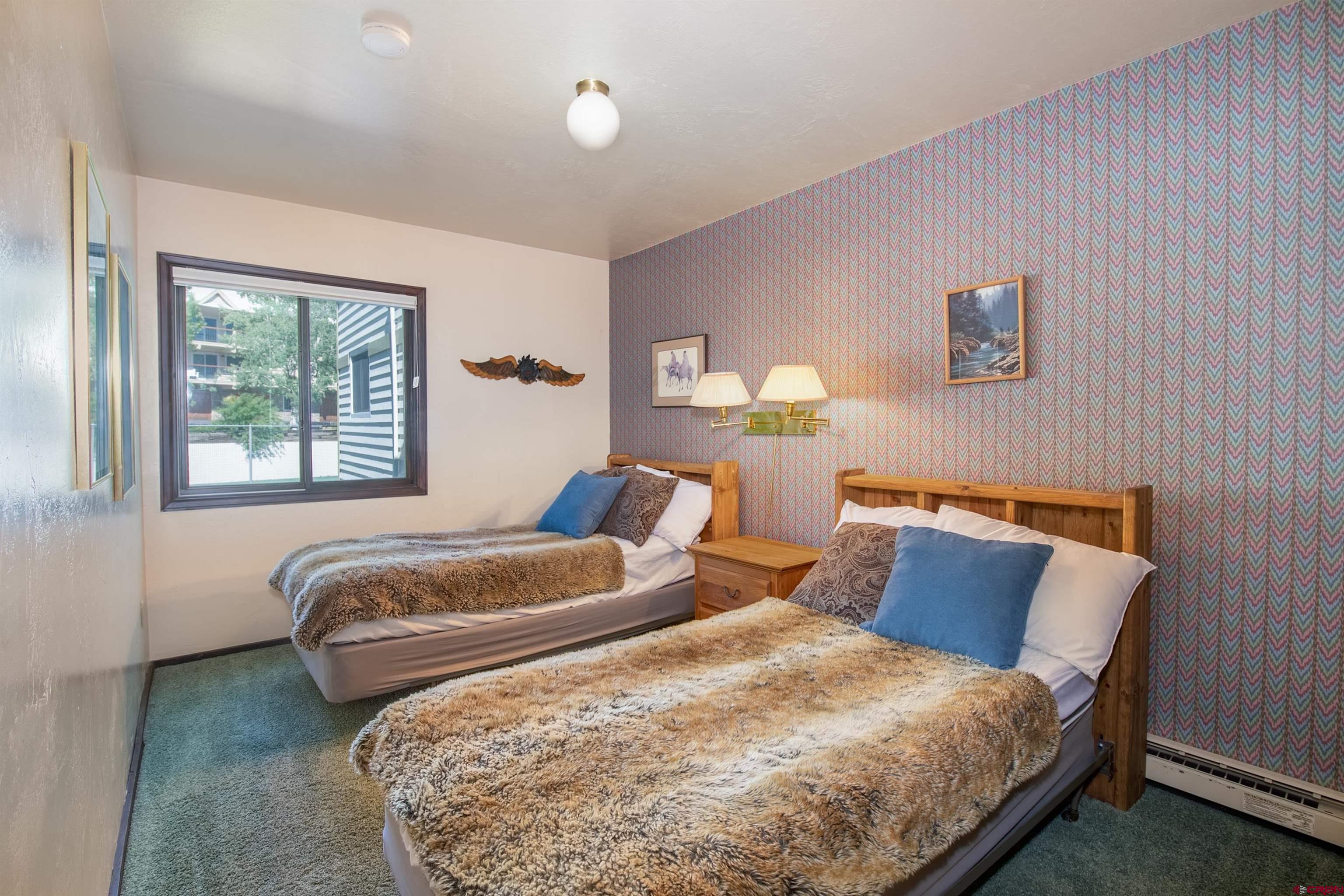 721 Gothic Road, Unit C3 Crested Butte, CO 81225 - Photo 11 of 33 a bedroom with two beds and a window