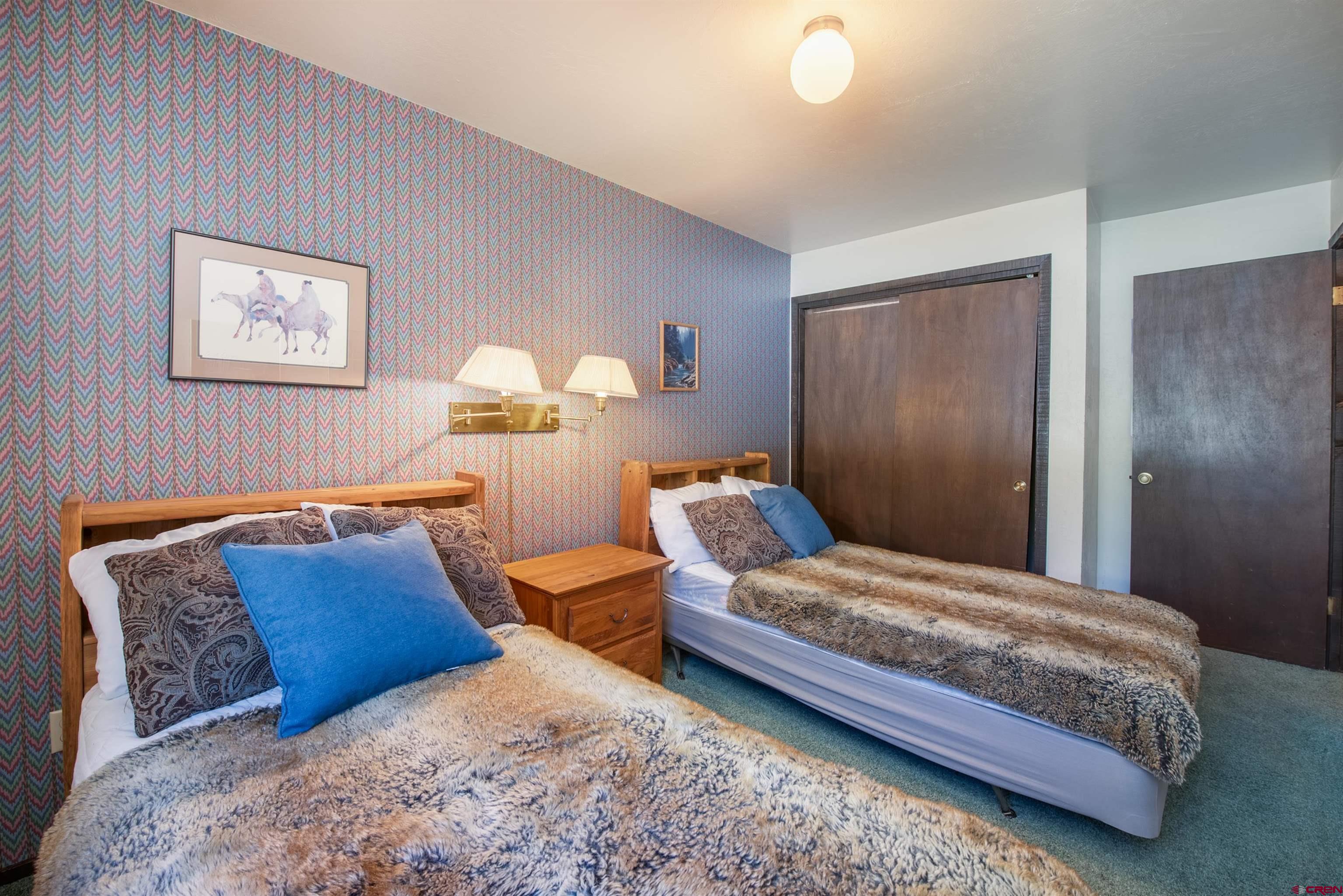 721 Gothic Road, Unit C3 Crested Butte, CO 81225 - Photo 12 of 33 a bedroom with a bed and a couch