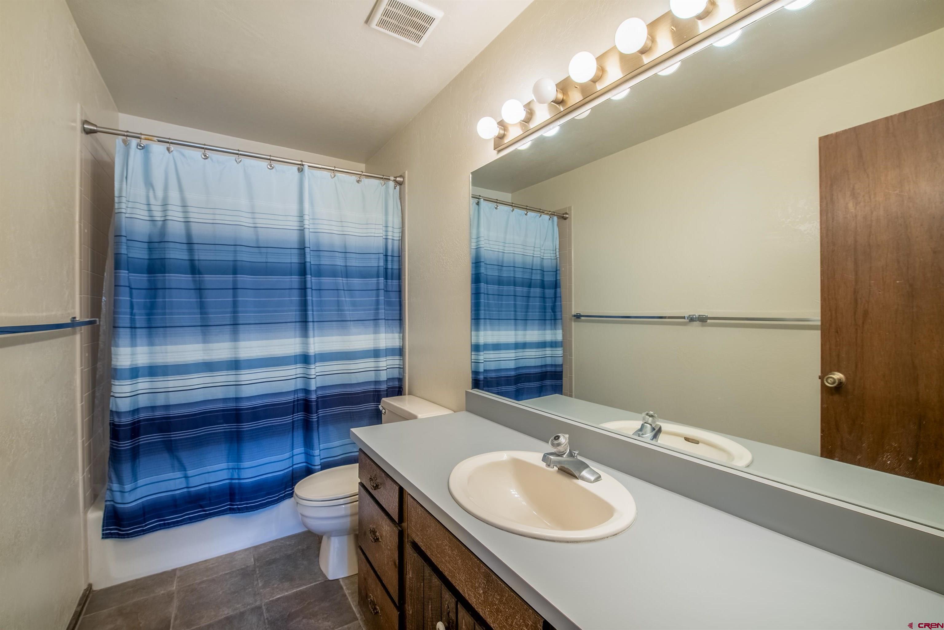 721 Gothic Road, Unit C3 Crested Butte, CO 81225 - Photo 13 of 33 a bathroom with a sink toilet a mirror and shower