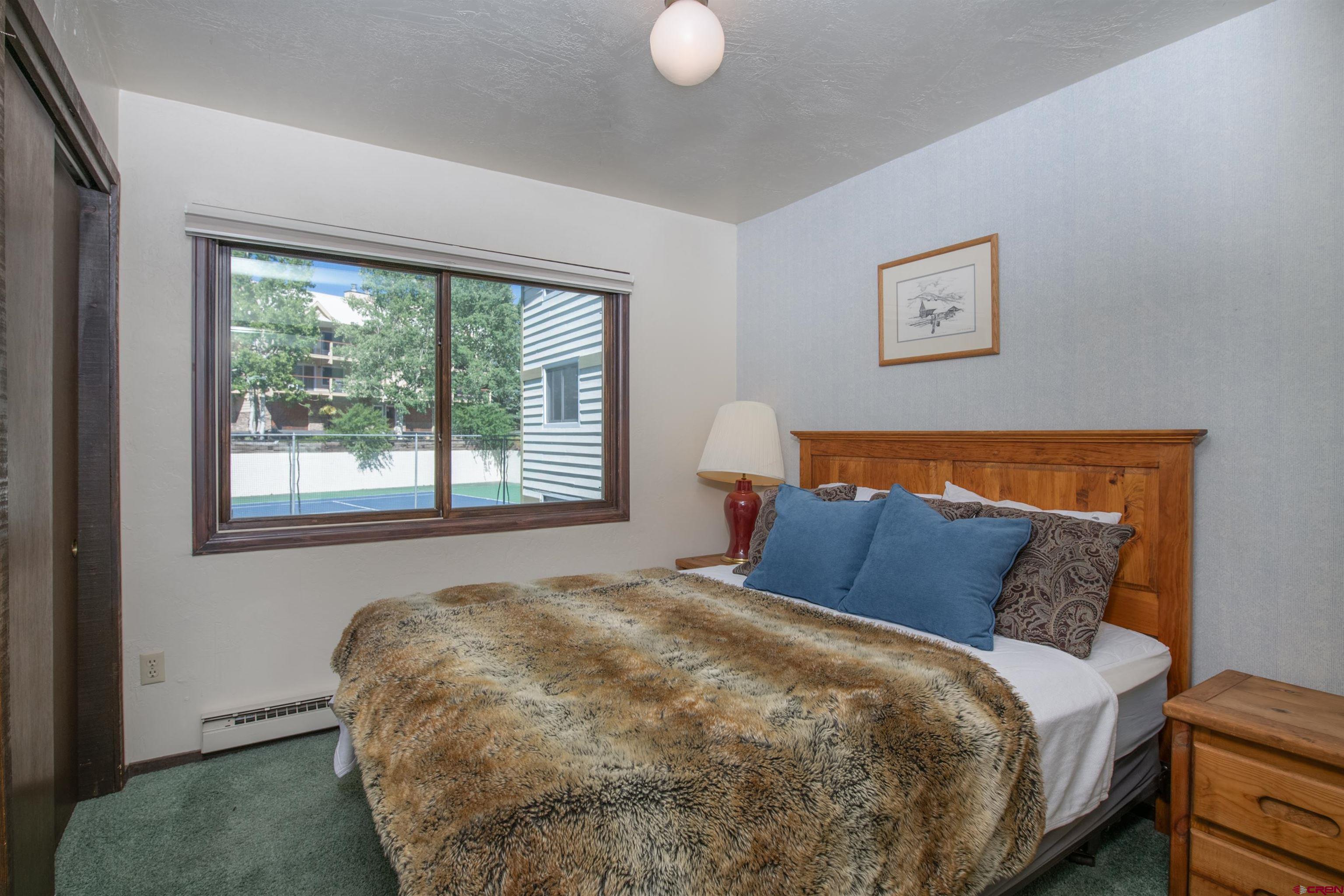 721 Gothic Road, Unit C3 Crested Butte, CO 81225 - Photo 14 of 33 a bedroom with a bed and a window