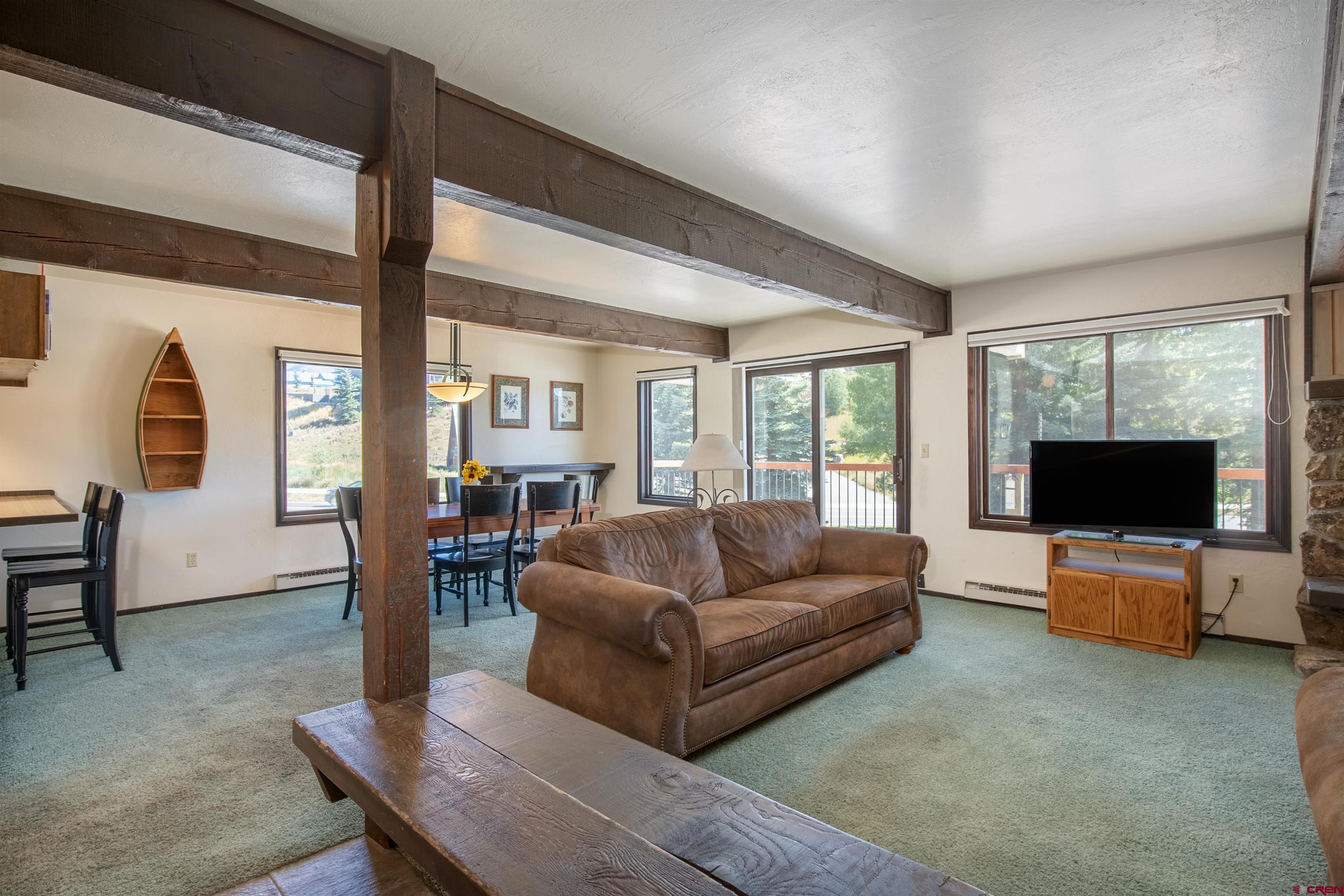 721 Gothic Road, Unit C3 Crested Butte, CO 81225 - Photo 2 of 33 a living room with furniture and a flat screen tv