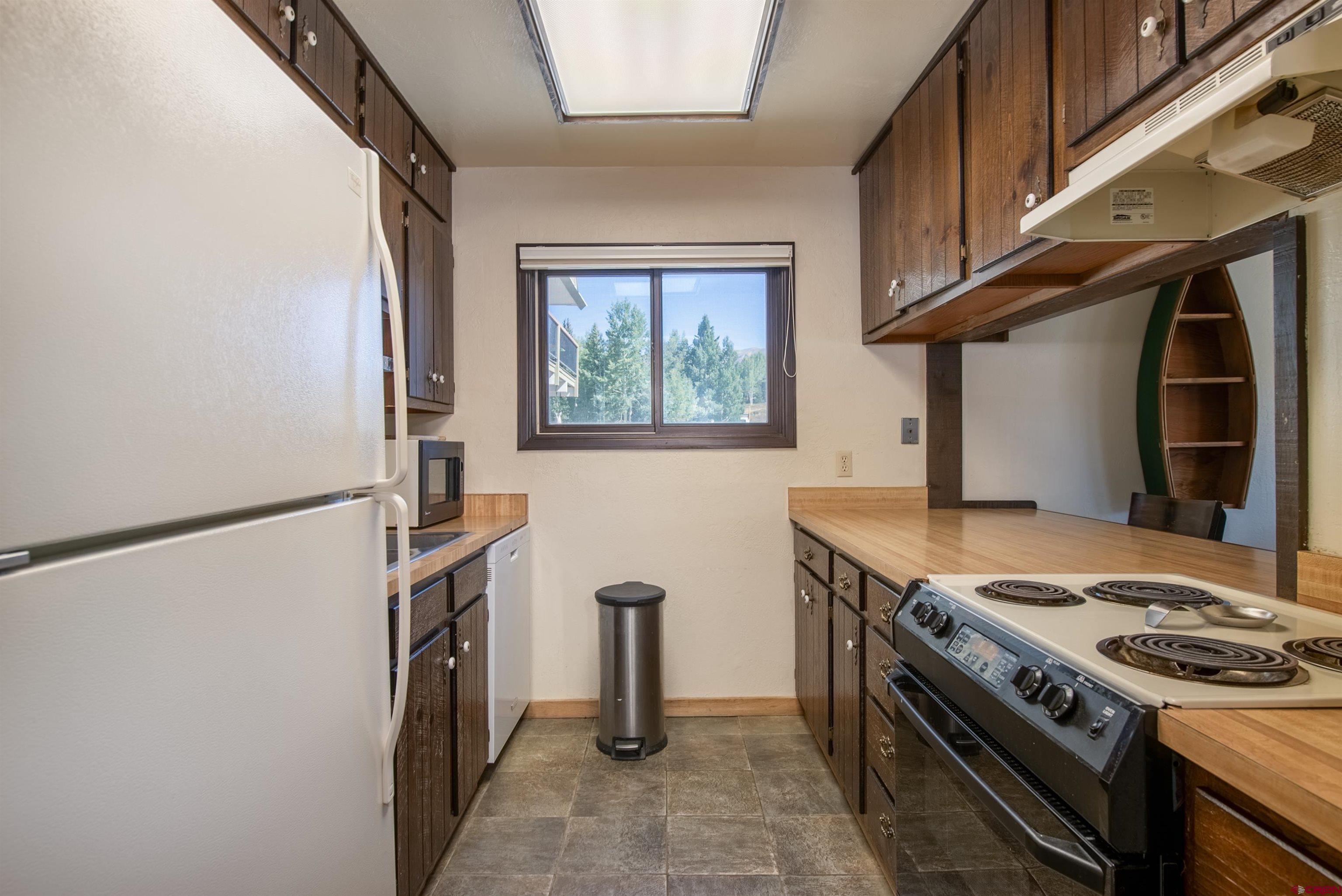 721 Gothic Road, Unit C3 Crested Butte, CO 81225 - Photo 6 of 33 a kitchen with stainless steel appliances granite countertop a refrigerator and a stove top oven