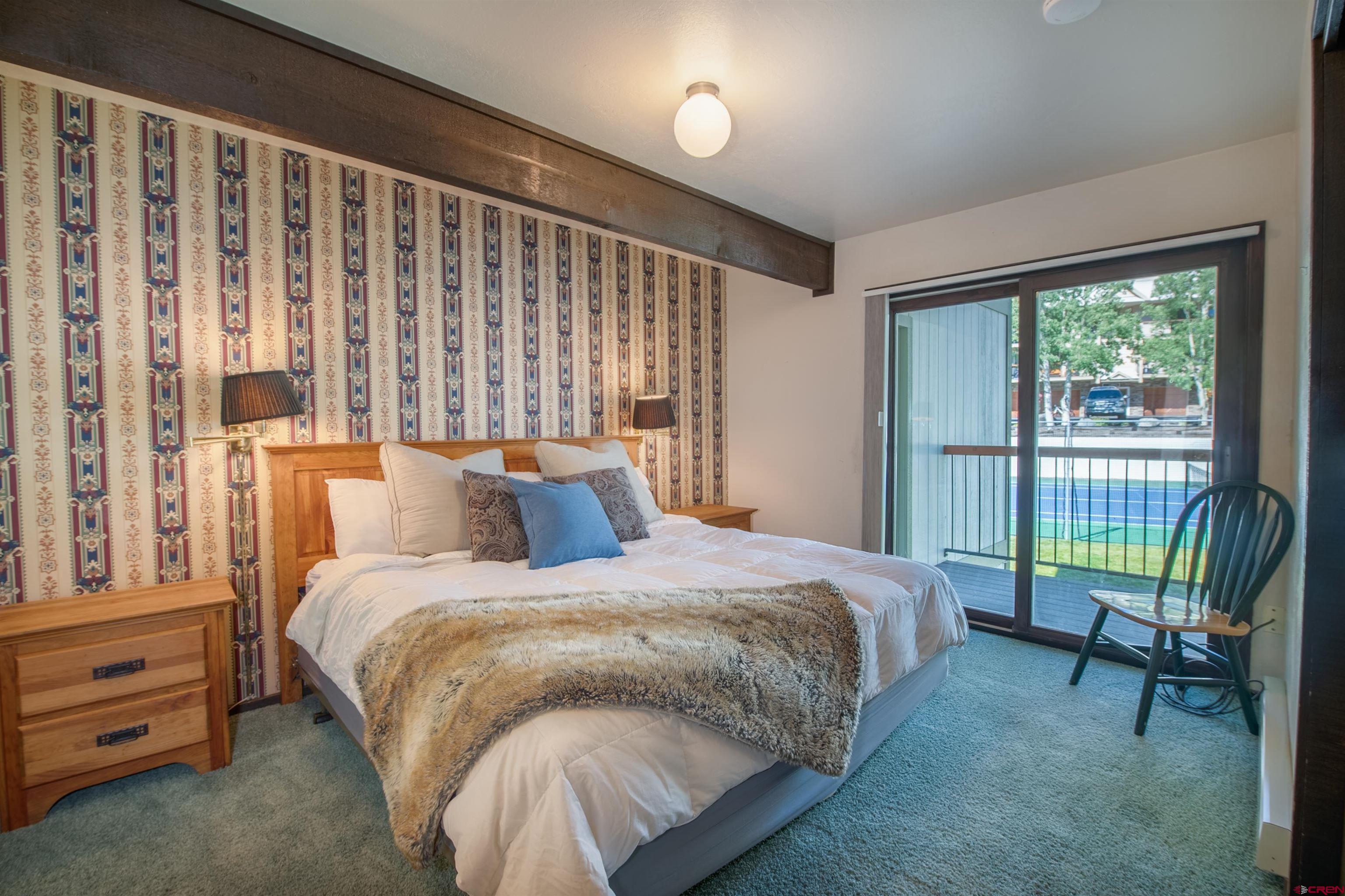 721 Gothic Road, Unit C3 Crested Butte, CO 81225 - Photo 8 of 33 a bed sitting in a bedroom next to a window