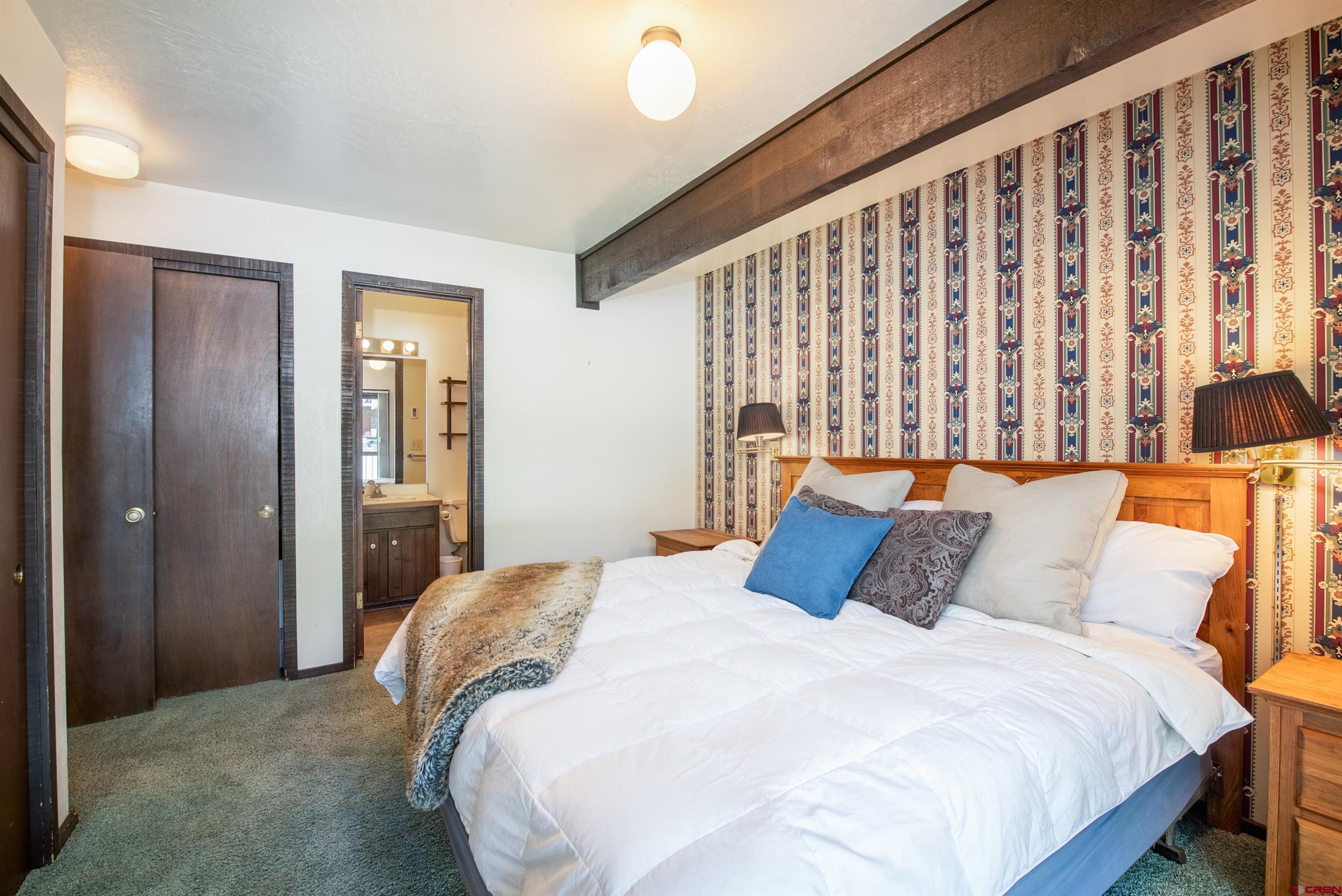 721 Gothic Road, Unit C3 Crested Butte, CO 81225 - Photo 9 of 33 a bedroom with a bed and wooden floor