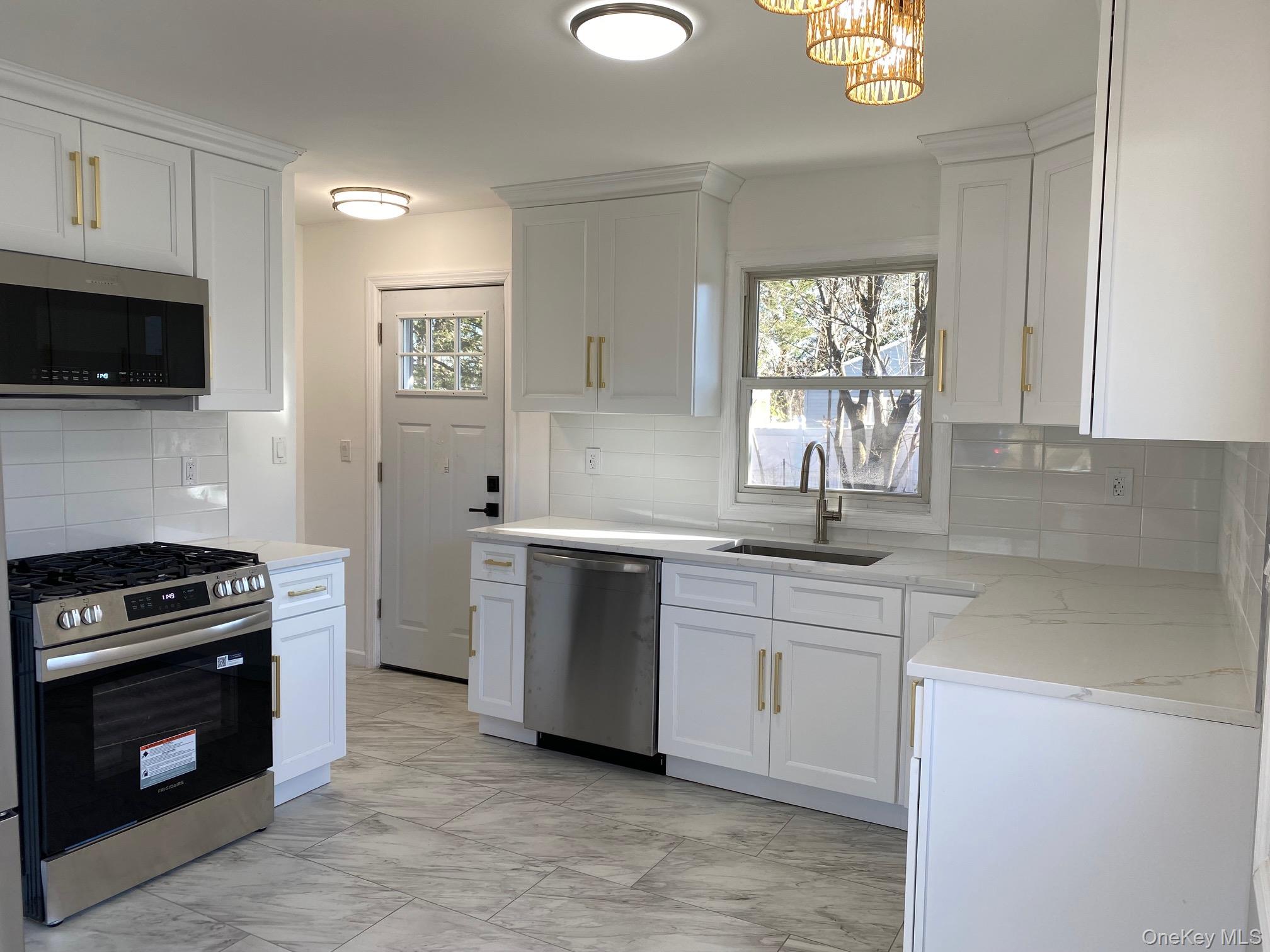 5 Smith Road Cornwall, NY 12518 - Photo 6 of 32 Kitchen with appliances with stainless steel finishes, tasteful backsplash, white cabinets, and light marble finish floors