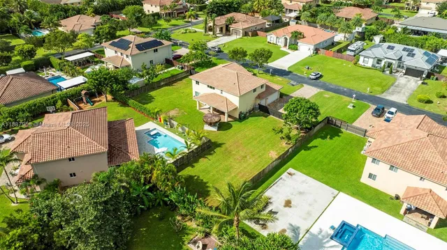 an aerial view of a house with a garden and swimming pool