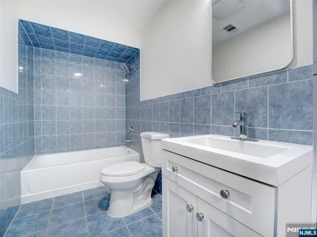 a bathroom with a sink a toilet and bathtub