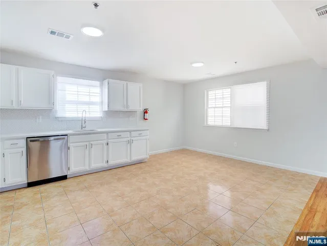 a kitchen with granite countertop a sink and cabinets