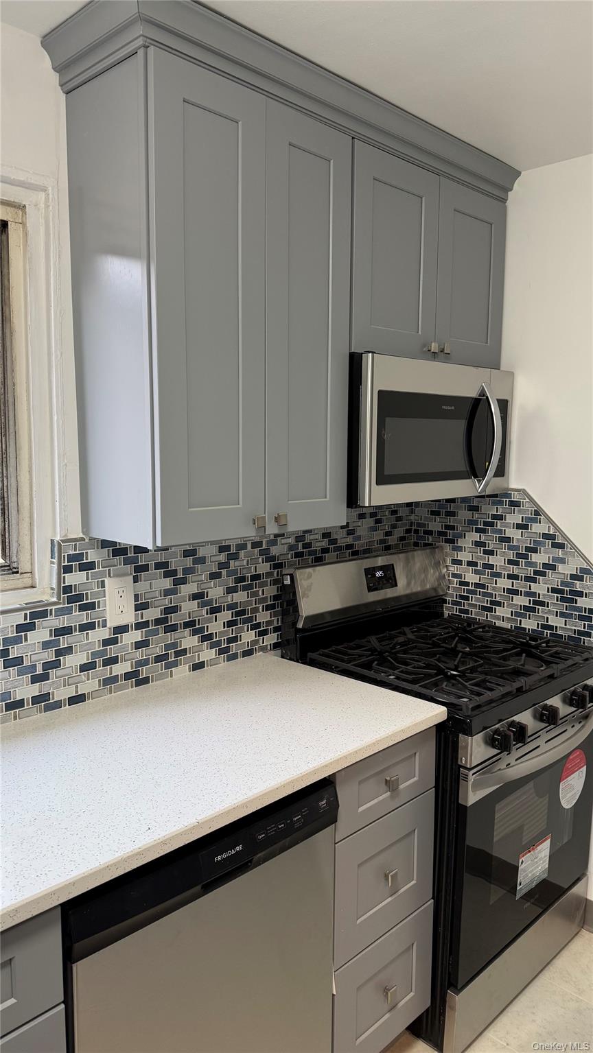 a kitchen with granite countertop a sink and a stove