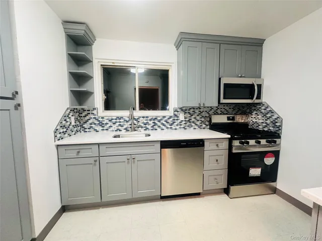 a kitchen with a sink and stove top oven