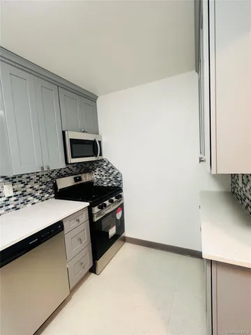 a kitchen with a sink stove and microwave