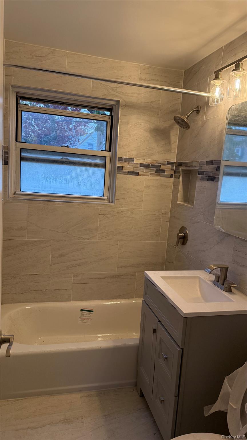 1003 Rottkamp Street, Unit 1 Valley Stream, NY 11580 - Photo 4 of 16 a bathroom with a sink and a bathtub