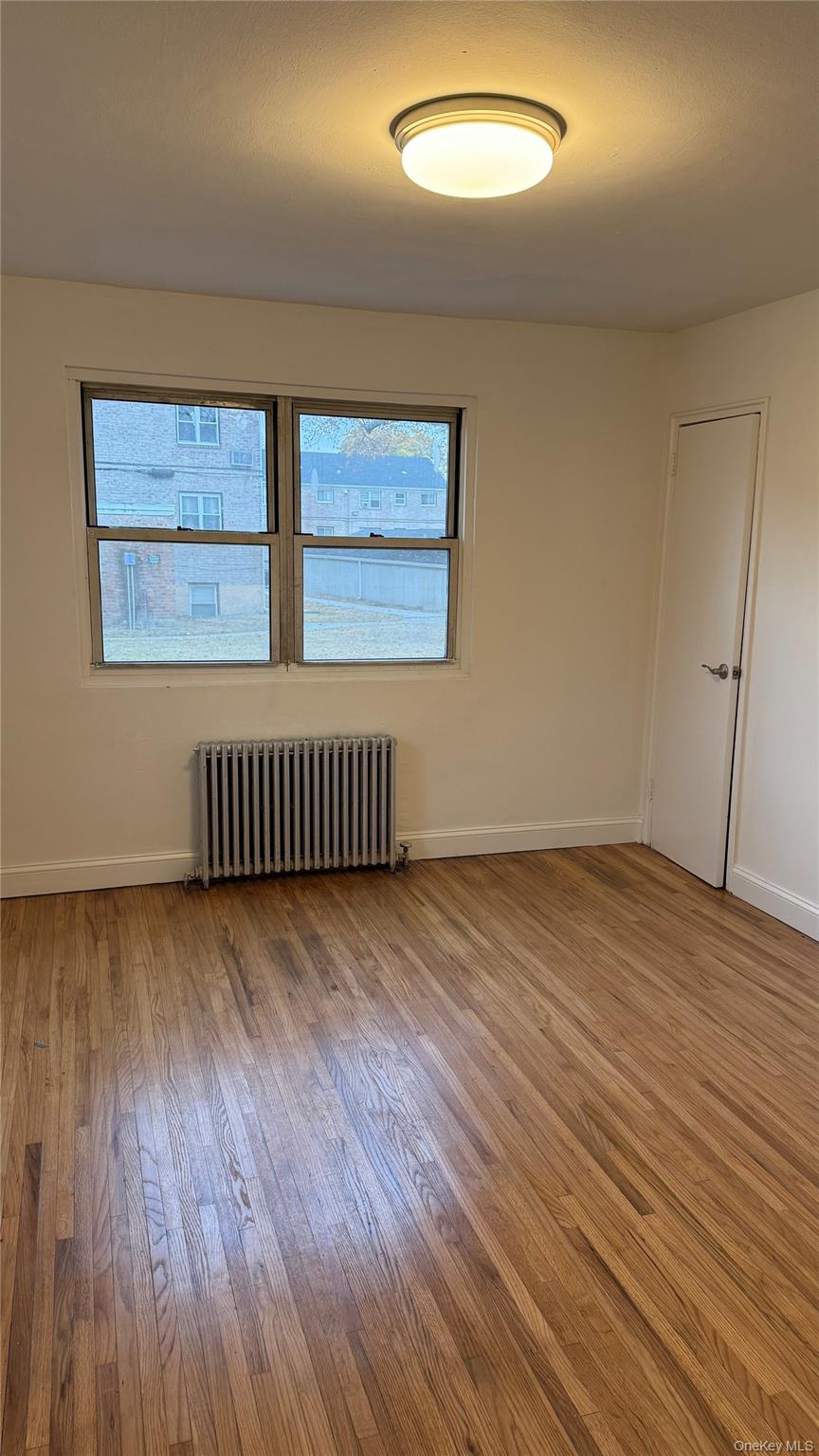 1003 Rottkamp Street, Unit 1 Valley Stream, NY 11580 - Photo 5 of 16 an empty room with wooden floor