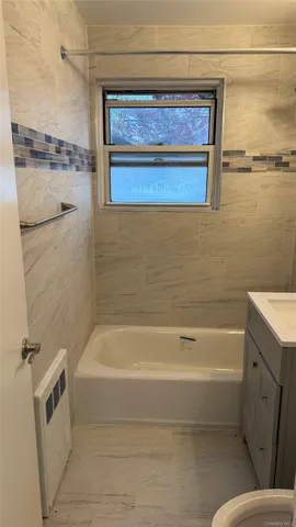 a bathroom with a bathtub and a shower