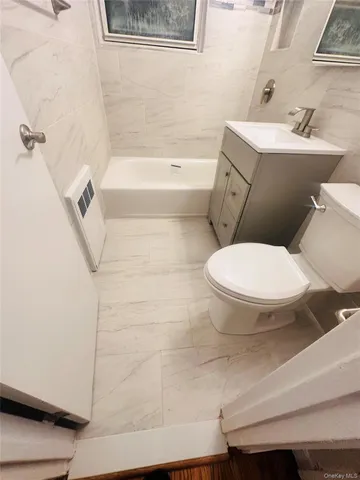 a bathroom with a toilet and a bathtub