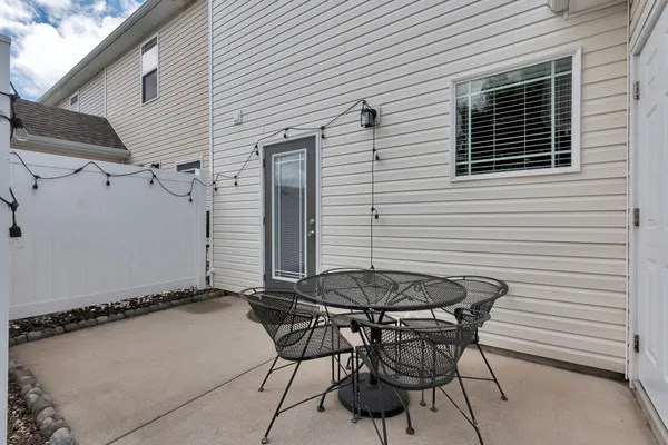 a backyard of a house with table and chairs