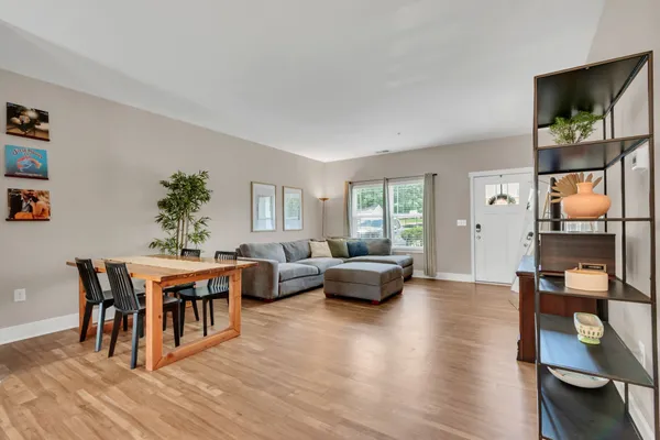 a living room with furniture wooden floor and a window