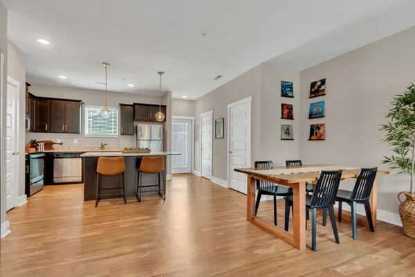 a view of kitchen with cabinets table and chairs