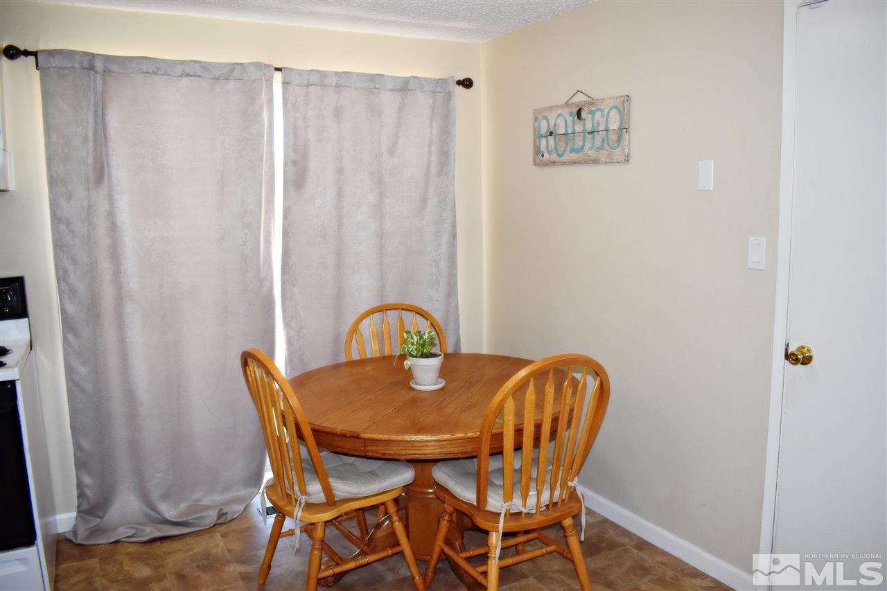 9185 Fremont Way Reno, NV 89506 - Photo 5 of 10 a dining room with furniture and a window