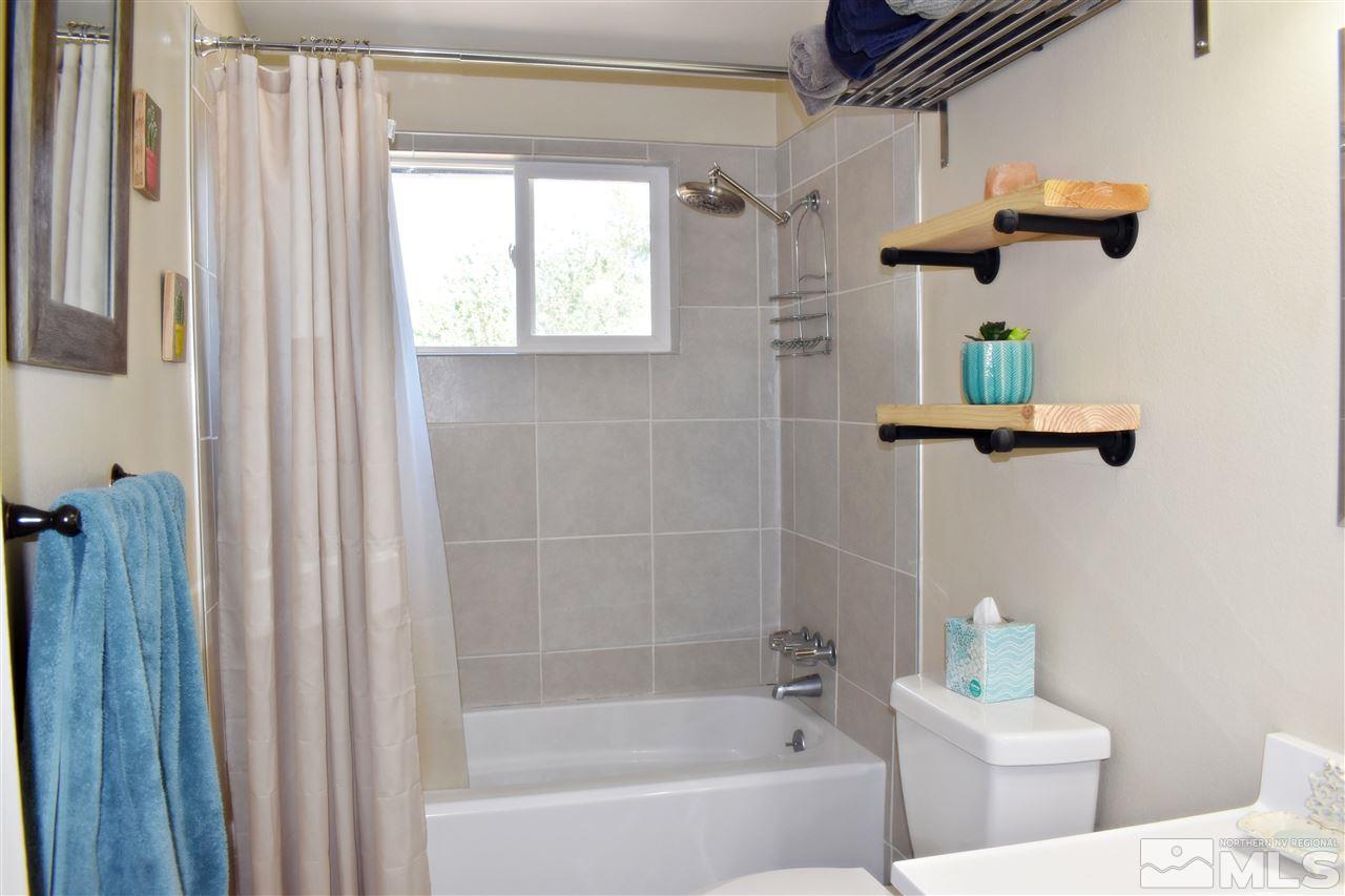 9185 Fremont Way Reno, NV 89506 - Photo 8 of 10 a bathroom with a shower a bath tub and shower