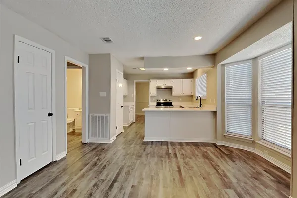 a view of kitchen with wooden floor and electronic appliances
