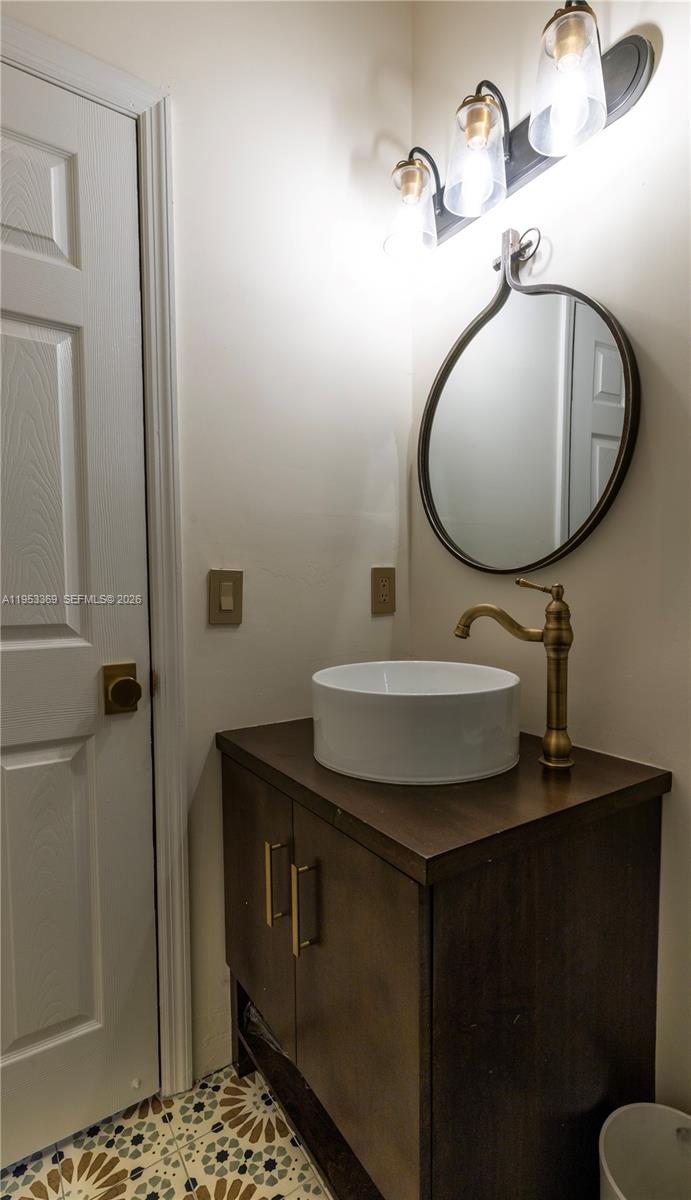 13276 Southwest 128th Street Miami, FL 33186 - Photo 13 of 43 a bathroom with a sink and a mirror